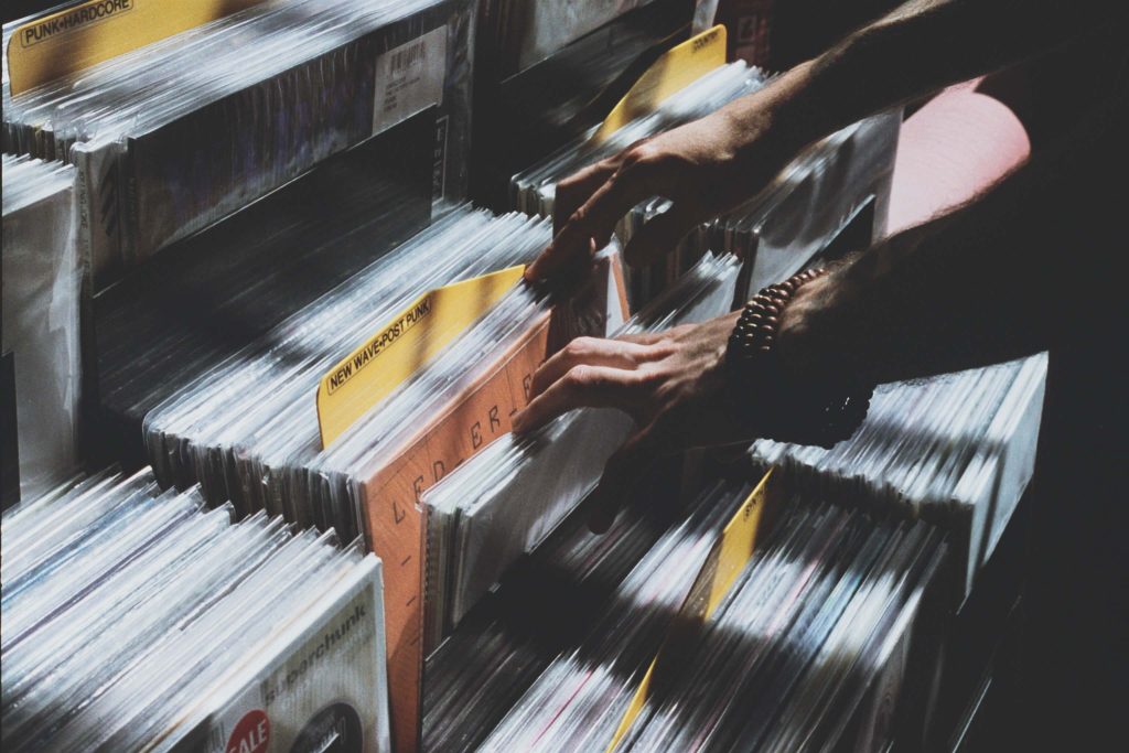 Someone flipping through vinyl records